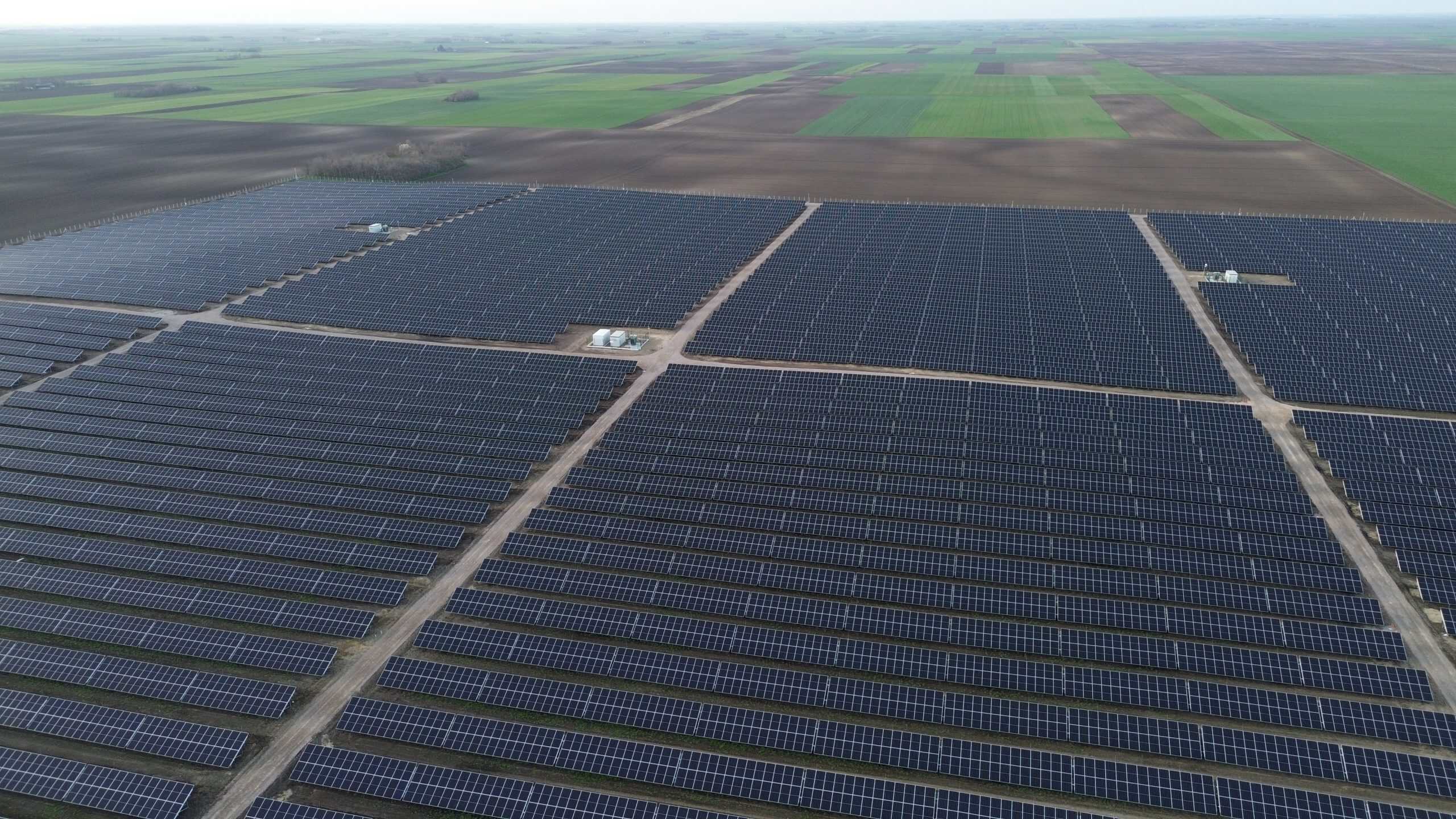 Aerial view of a large 20 MW solar power plant in North Banat, showcasing extensive solar panel arra.