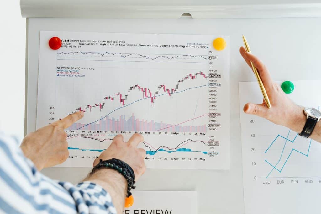 Two professionals analyze stock market graphs with a focus on finance and data trends.