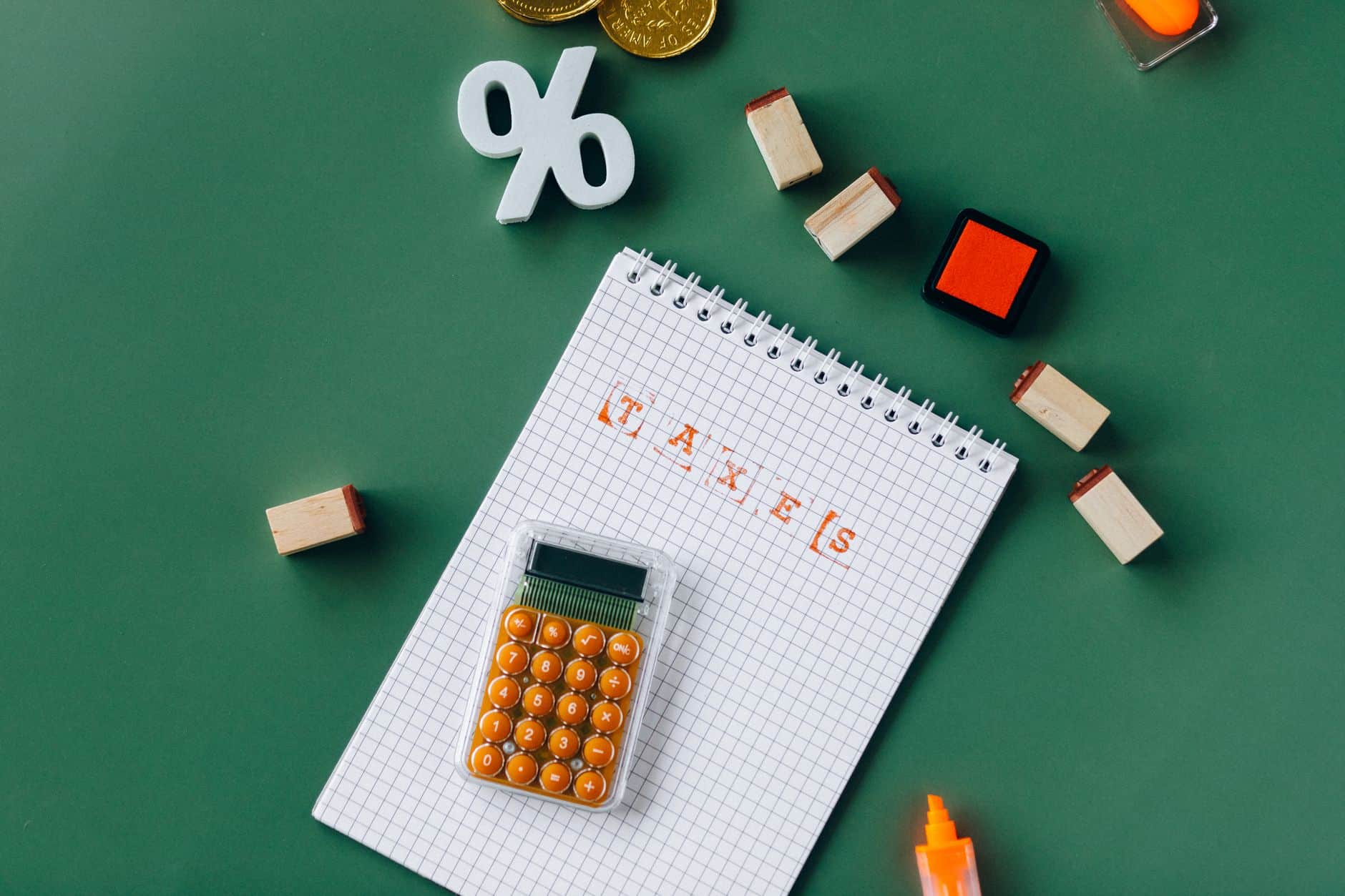 Financial planning with calculator and notes on green background.